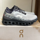 Tênis On Running Cloudmonster Cinza/Branco
